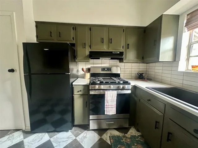 a kitchen with a refrigerator and a sink