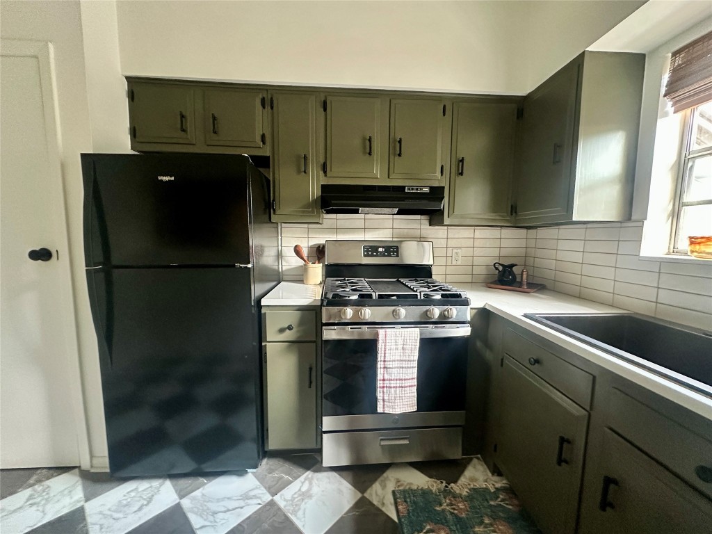 1700 Houston Street, Unit 201 Austin, TX 78756 - Photo 18 of 26 a kitchen with a refrigerator and a sink