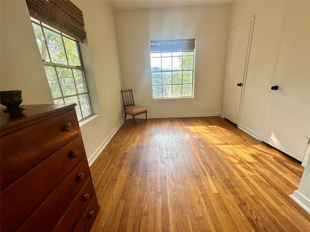 1700 Houston Street, Unit 201 Austin, TX 78756 - Photo 23 of 26 an empty room with wooden floor and windows