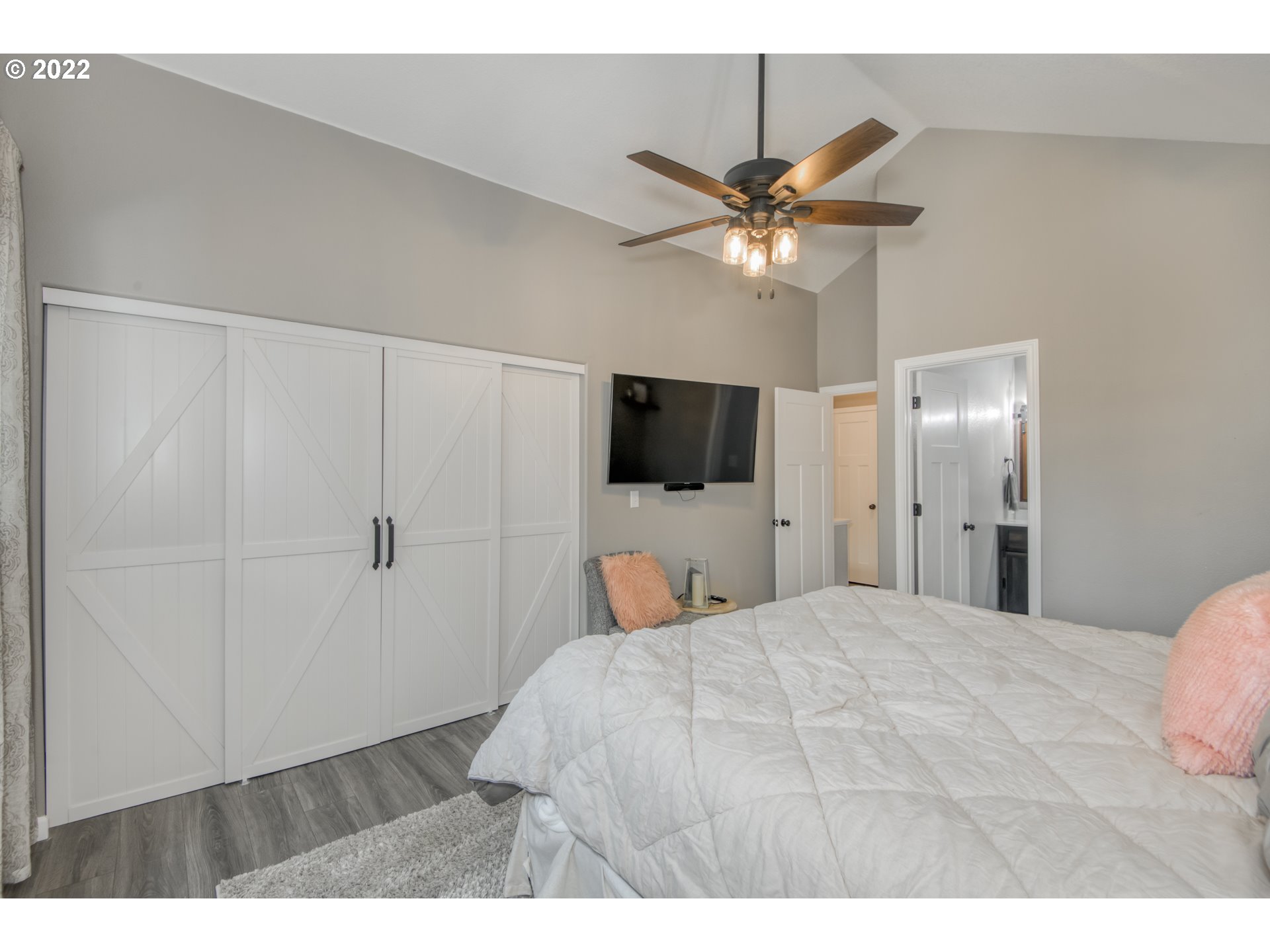 10463 Southwest Laurel Road Beaverton, OR 97005 - Photo 18 of 28 a bedroom with a bed and a flat screen tv