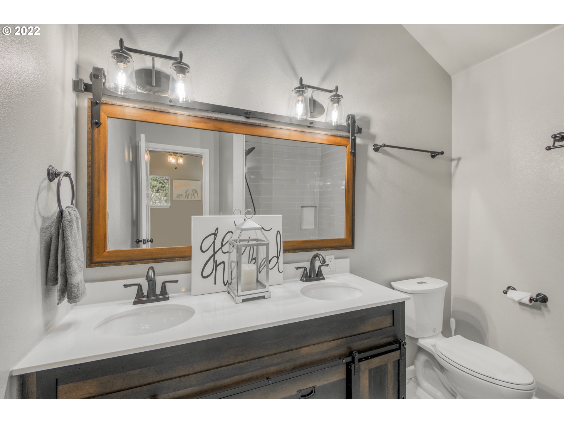 10463 Southwest Laurel Road Beaverton, OR 97005 - Photo 19 of 28 a bathroom with a sink and a mirror