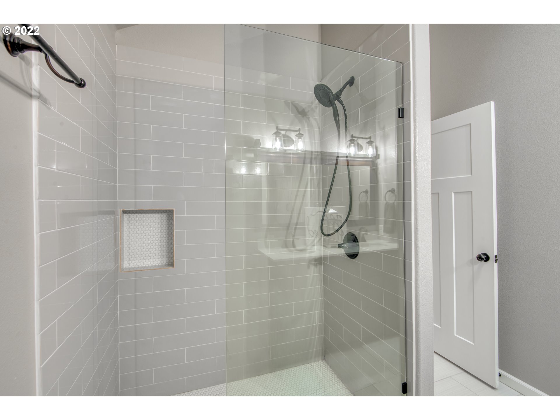 10463 Southwest Laurel Road Beaverton, OR 97005 - Photo 20 of 28 a bathroom with a glass shower door