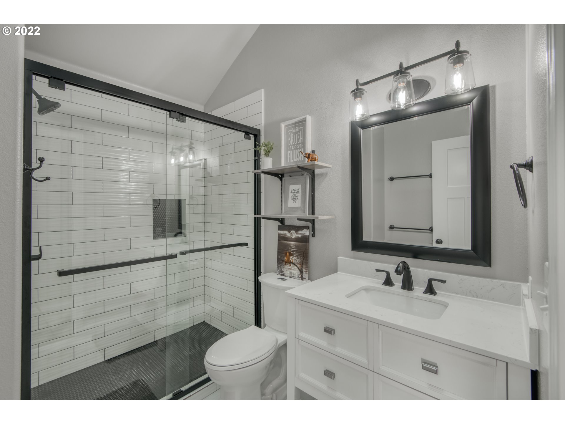10463 Southwest Laurel Road Beaverton, OR 97005 - Photo 22 of 28 a bathroom with a shower sink and mirror