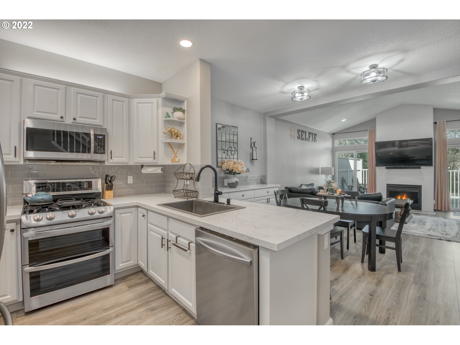 10463 Southwest Laurel Road Beaverton, OR 97005 - Photo 6 of 28 a kitchen with a sink stove and microwave