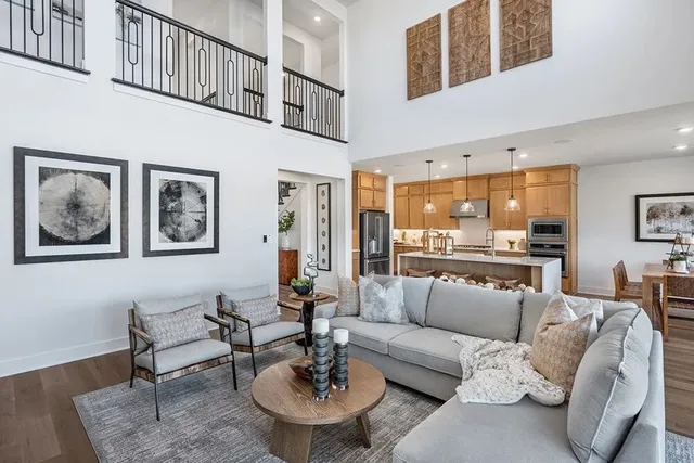 a living room with furniture and a dining table