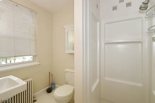 a white toilet sitting next to a bathroom sink
