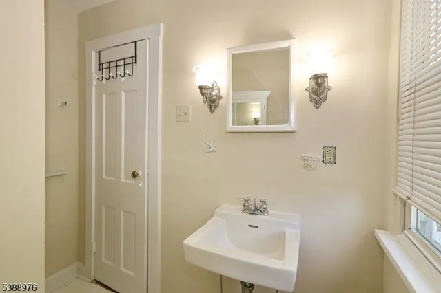 a bathroom with a sink a mirror and a toilet