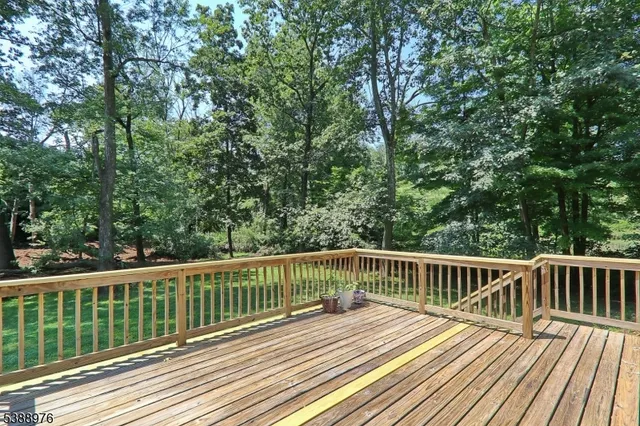 a view of balcony with wooden floor and fence