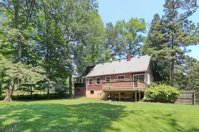 a view of a house with a yard and sitting area