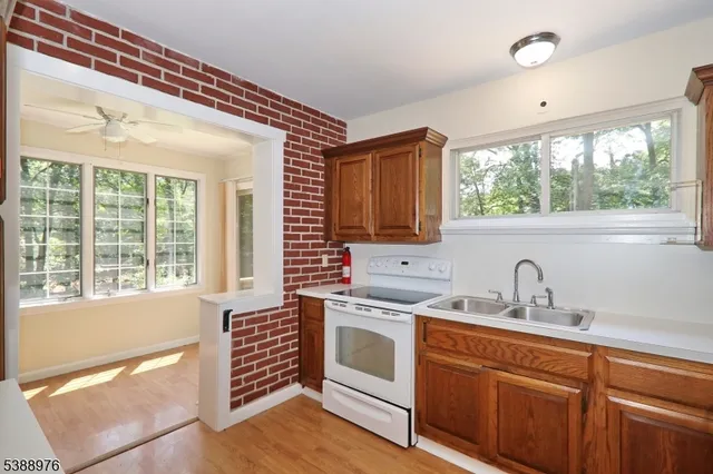 a kitchen with a stove a sink and cabinets