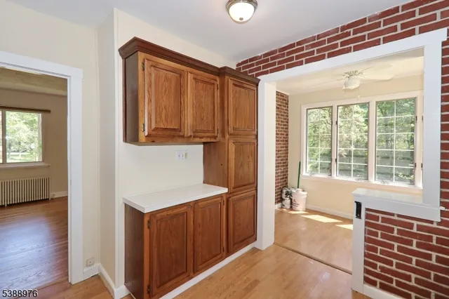 a view of hallway with a large window and wooden floor