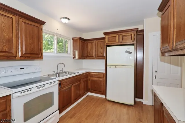 a kitchen with a refrigerator sink and cabinets