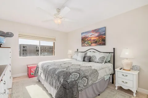 a bedroom with a bed and a painting on the wall