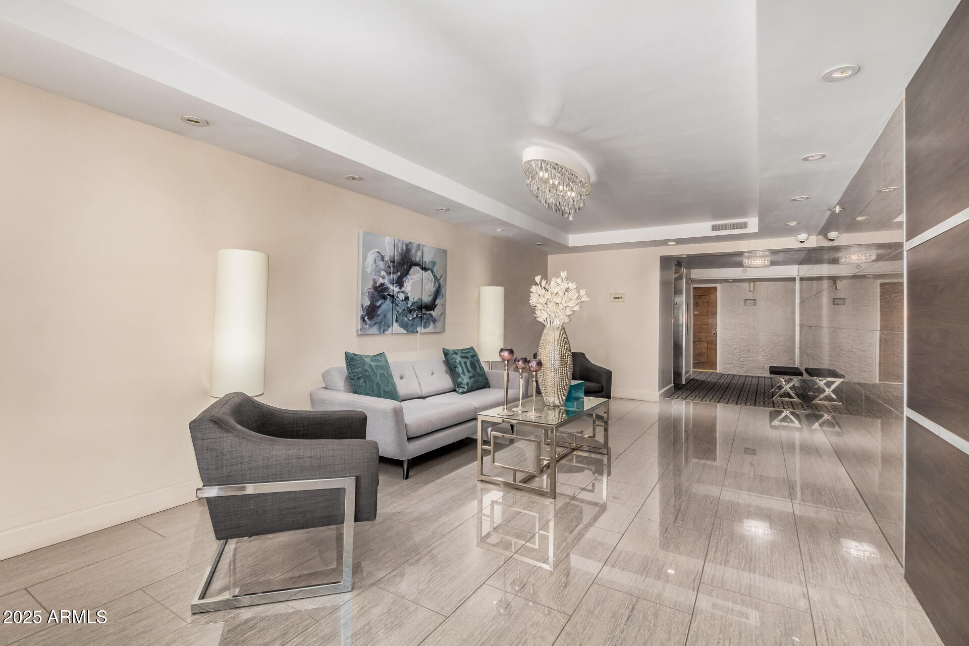 7970 East Camelback Road, Unit 611 Scottsdale, AZ 85251 - Photo 16 of 20 a living room with furniture and a chandelier