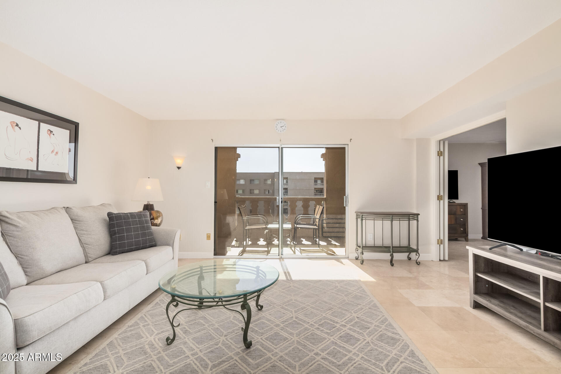 7970 East Camelback Road, Unit 611 Scottsdale, AZ 85251 - Photo 2 of 20 a living room with furniture and a flat screen tv