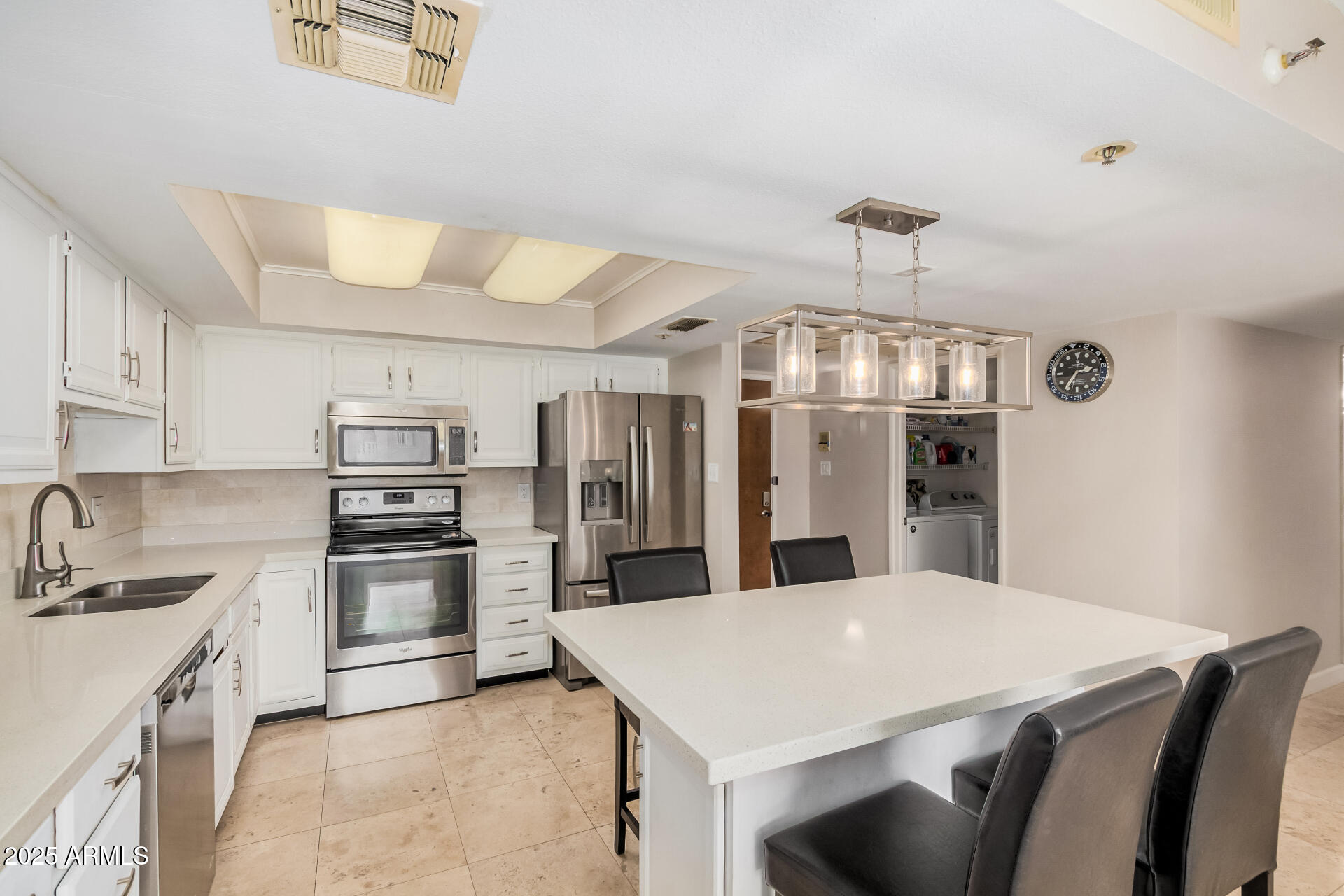 7970 East Camelback Road, Unit 611 Scottsdale, AZ 85251 - Photo 5 of 20 a kitchen with stainless steel appliances a sink a stove top oven a refrigerator and cabinets