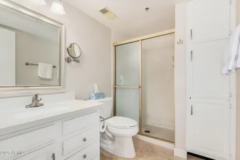 a bathroom with a toilet sink a shower and a mirror