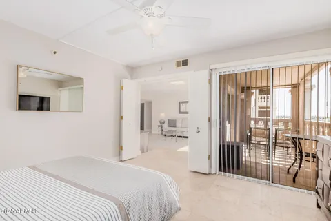 a bedroom with a bed and a large window