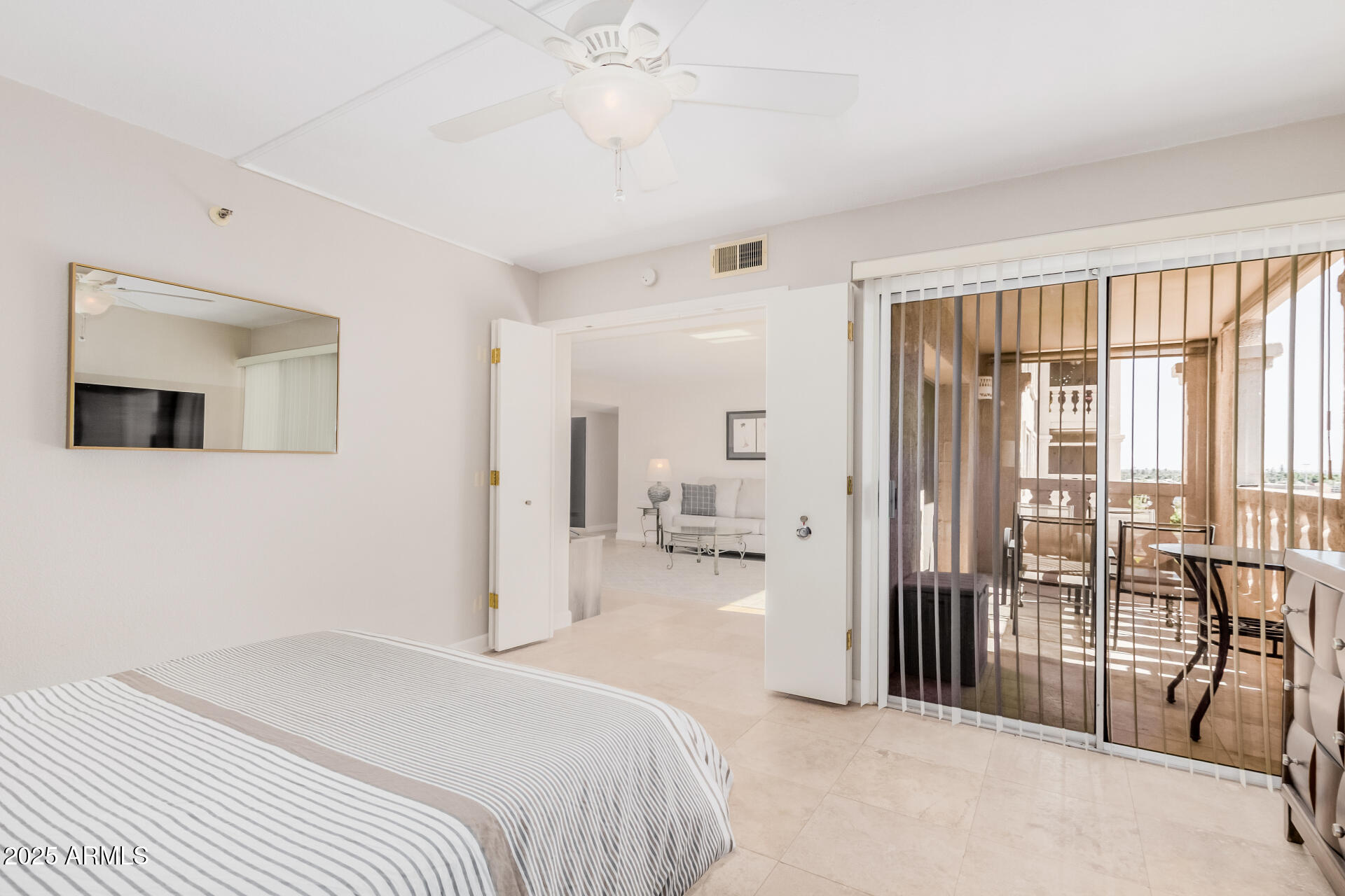 7970 East Camelback Road, Unit 611 Scottsdale, AZ 85251 - Photo 10 of 20 a bedroom with a bed and a large window