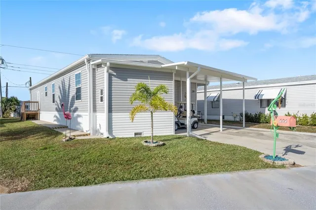 a view of a house with backyard and porch