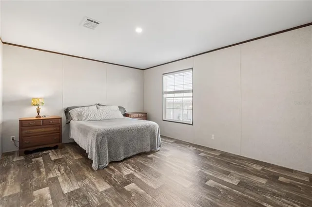 a spacious bedroom with a bed and a window