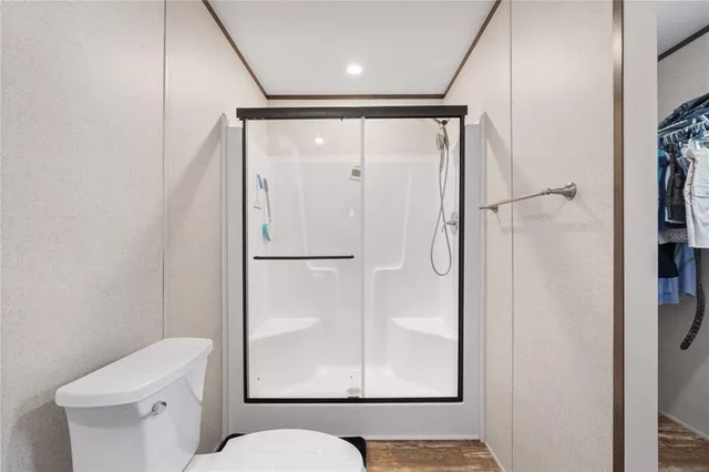 a bathroom with a shower and a toilet