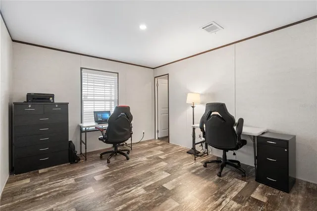 a view of a workspace with furniture and a window
