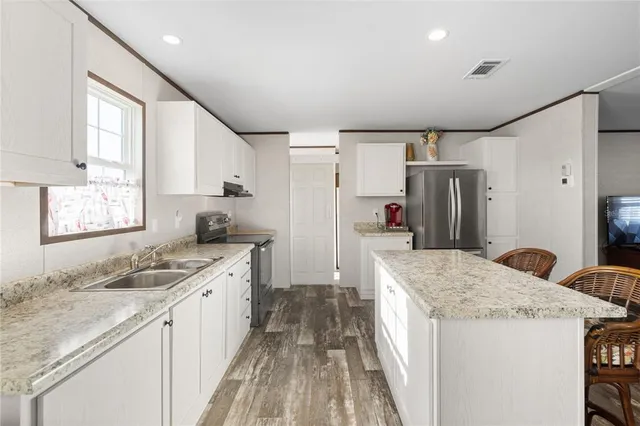 a kitchen with a sink stove and refrigerator