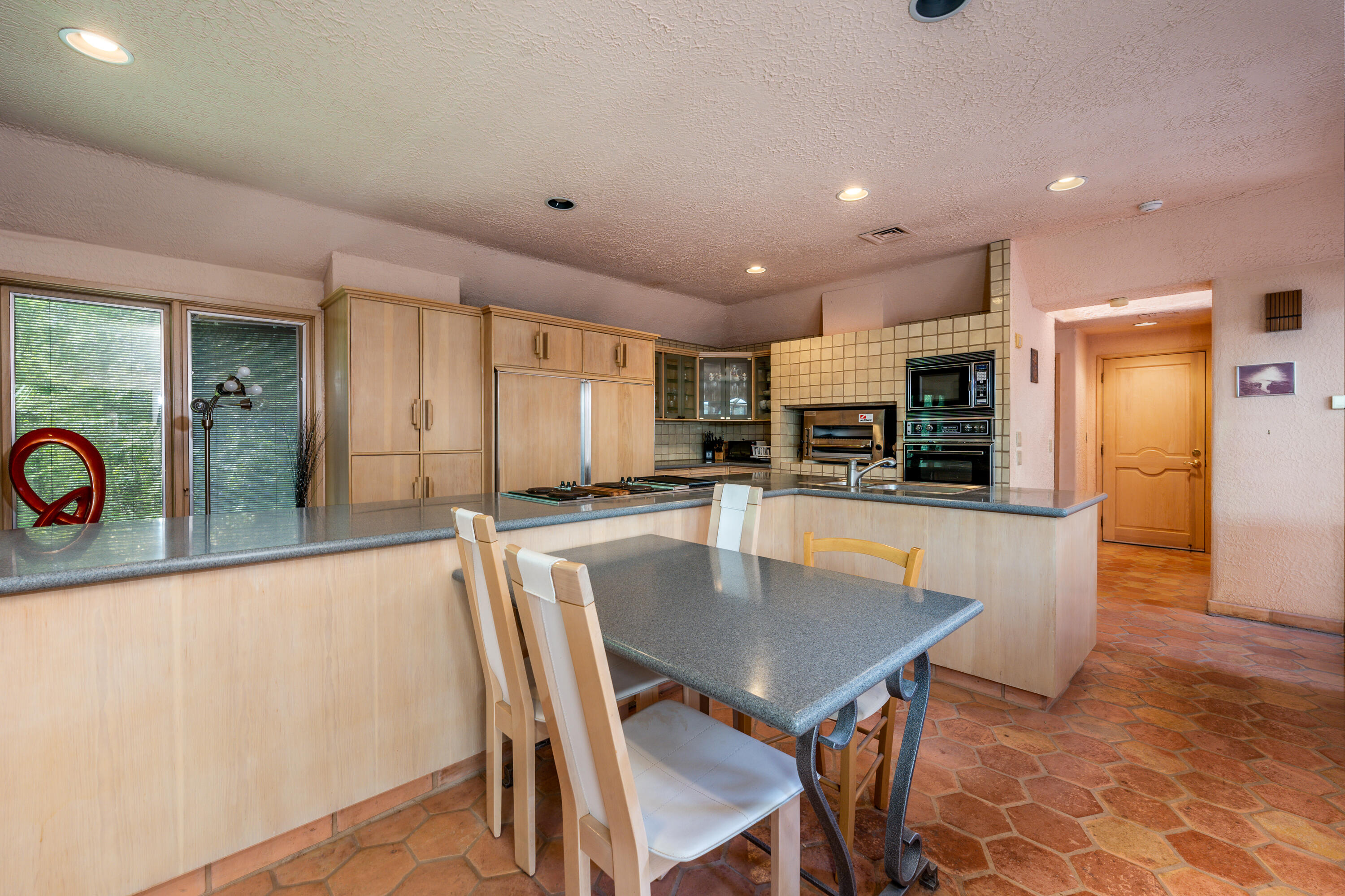 429 Elliott Road Centerville, MA 02632 - Photo 12 of 65 a kitchen with a table chairs microwave and refrigerator