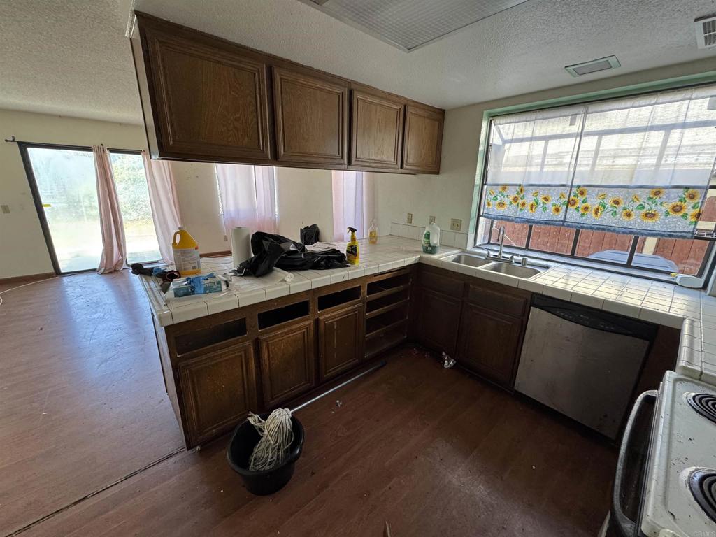 2845 Cottingham Street Oceanside, CA 92054 - Photo 4 of 11 a kitchen with a sink stove and cabinets
