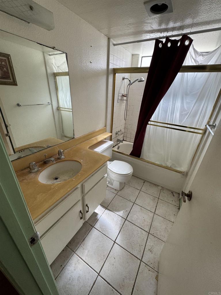 2845 Cottingham Street Oceanside, CA 92054 - Photo 5 of 11 a bathroom with a sink a toilet and a mirror