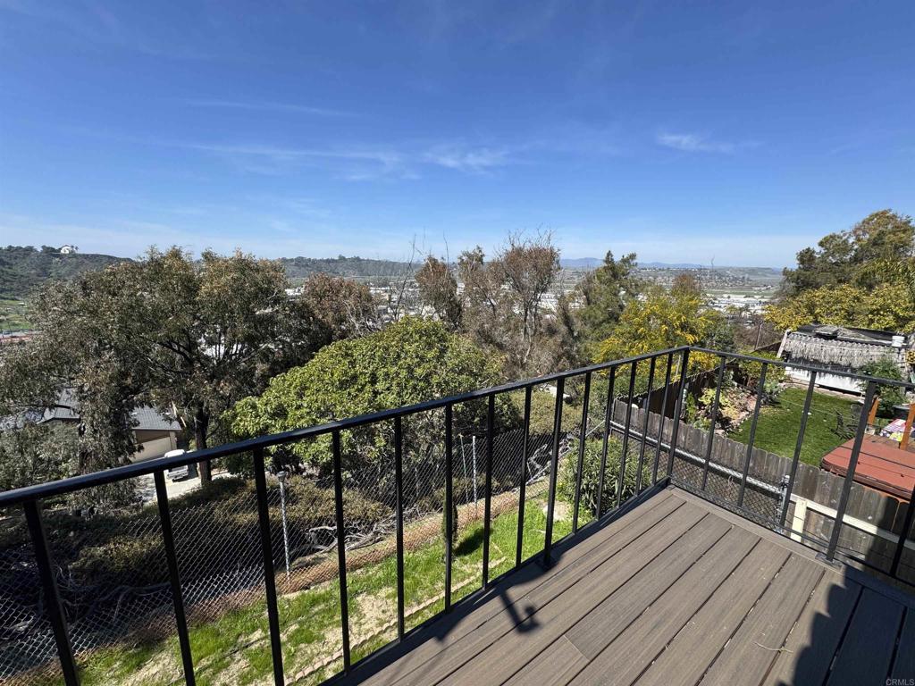 2845 Cottingham Street Oceanside, CA 92054 - Photo 8 of 11 a view of a balcony with wooden floor & fence
