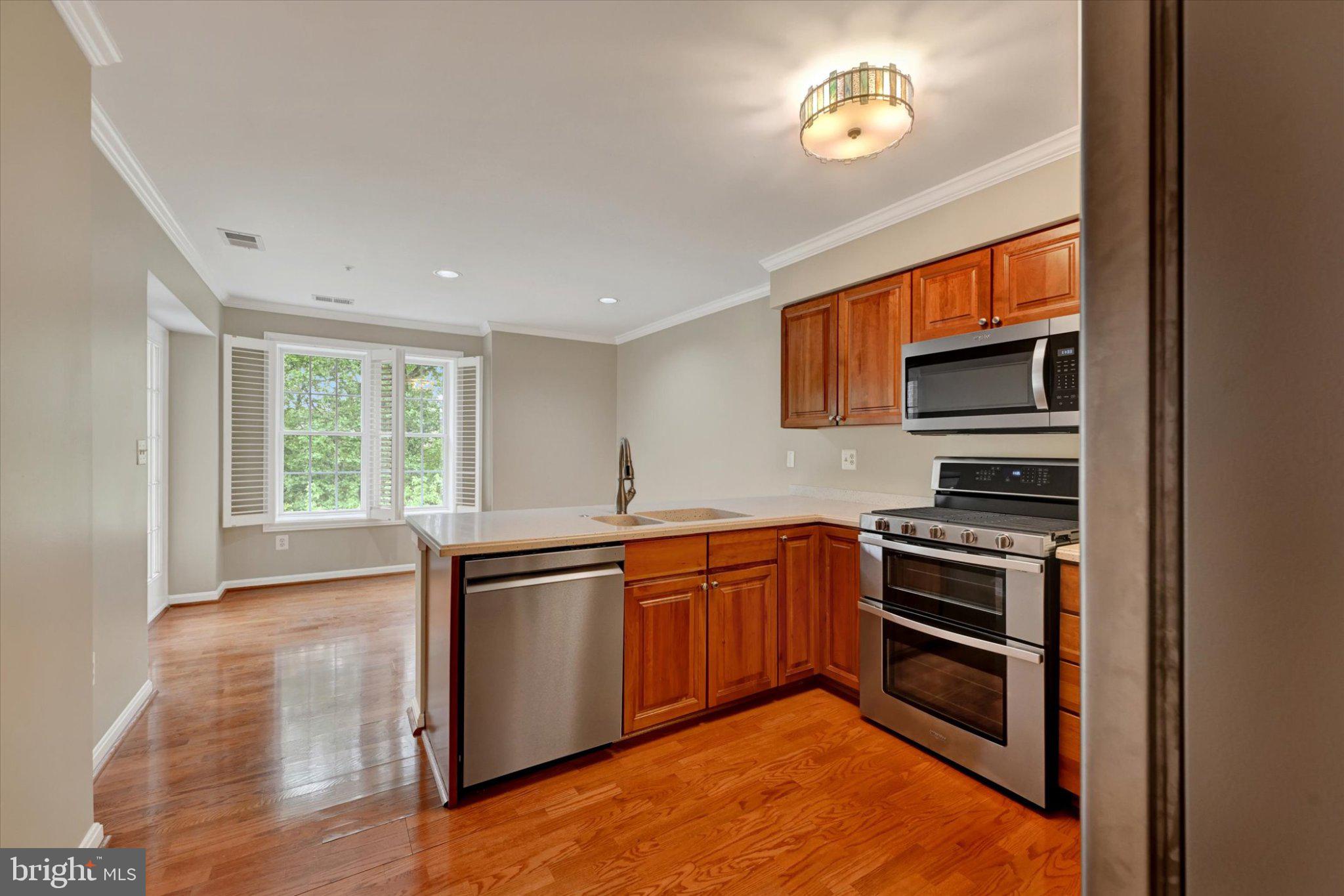 12310 Rosslare Ridge Road, Unit 405 Lutherville-Timonium, MD 21093 - Photo 11 of 36 Modern kitchen with warm wood accents.