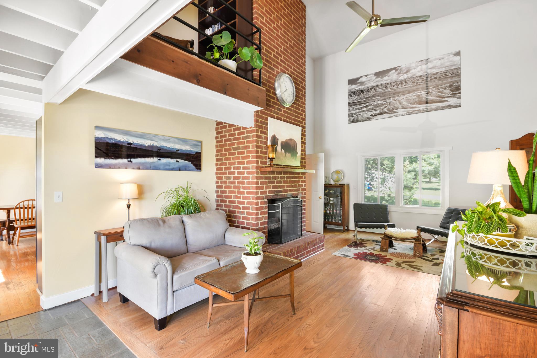 Two story living room with two-story brick FP