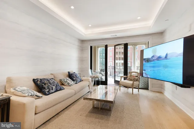 a living room with furniture large window and a rug