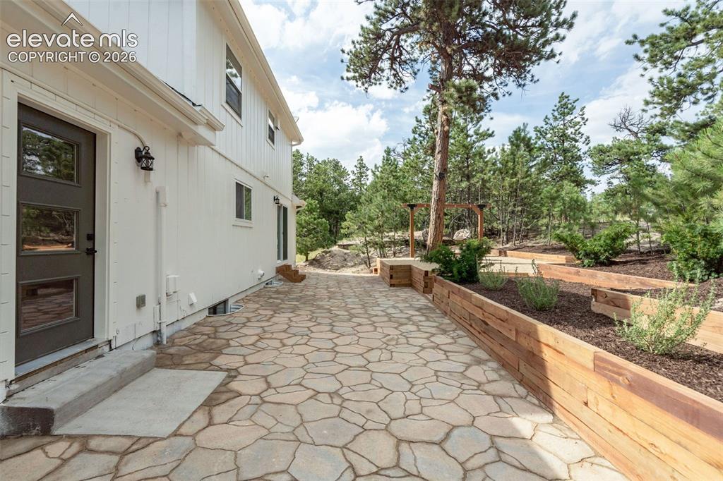 11665 Greentree Road Colorado Springs, CO 80908 - Photo 36 of 43 View of patio with view of wooded area