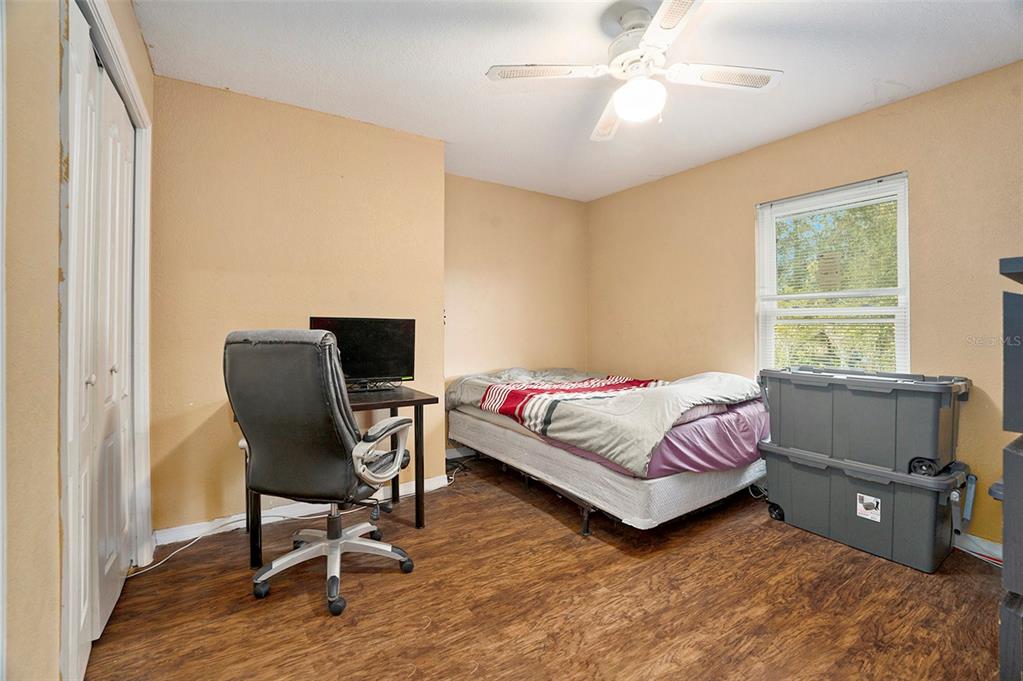 7309 Quail Meadow Road Plant City, FL 33565 - Photo 15 of 24 a bedroom with a bed and a chair