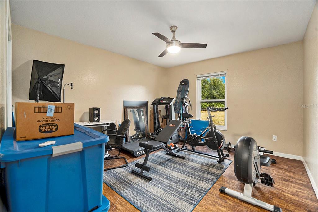 7309 Quail Meadow Road Plant City, FL 33565 - Photo 16 of 24 a view of a workspace with furniture and gym equipment