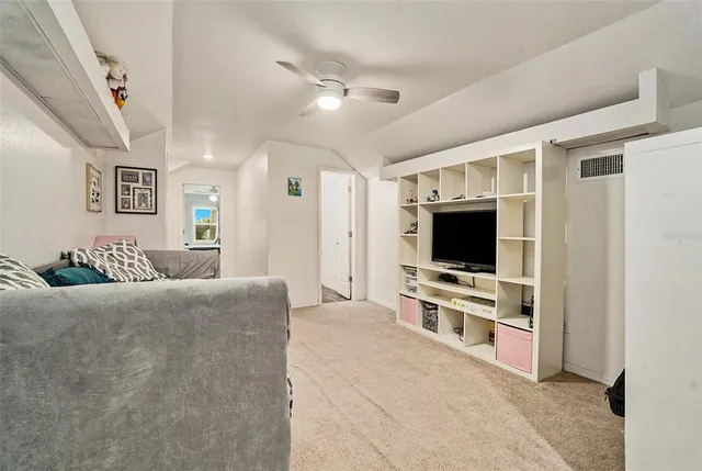 a living room with furniture and a lamp