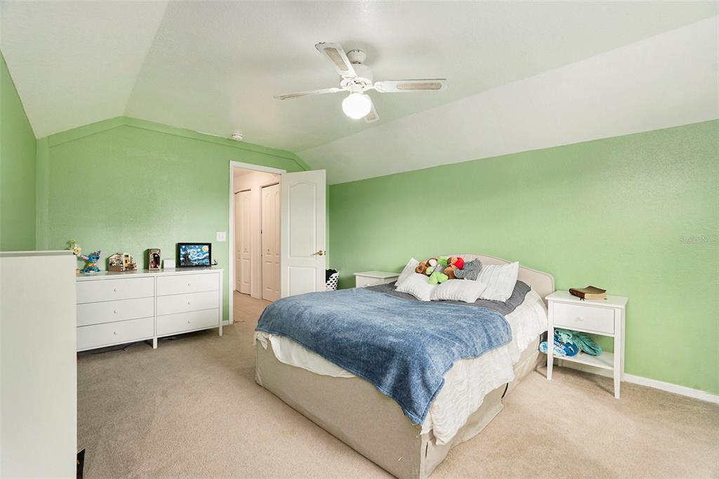 7309 Quail Meadow Road Plant City, FL 33565 - Photo 20 of 24 a bedroom with a bed and a chandelier