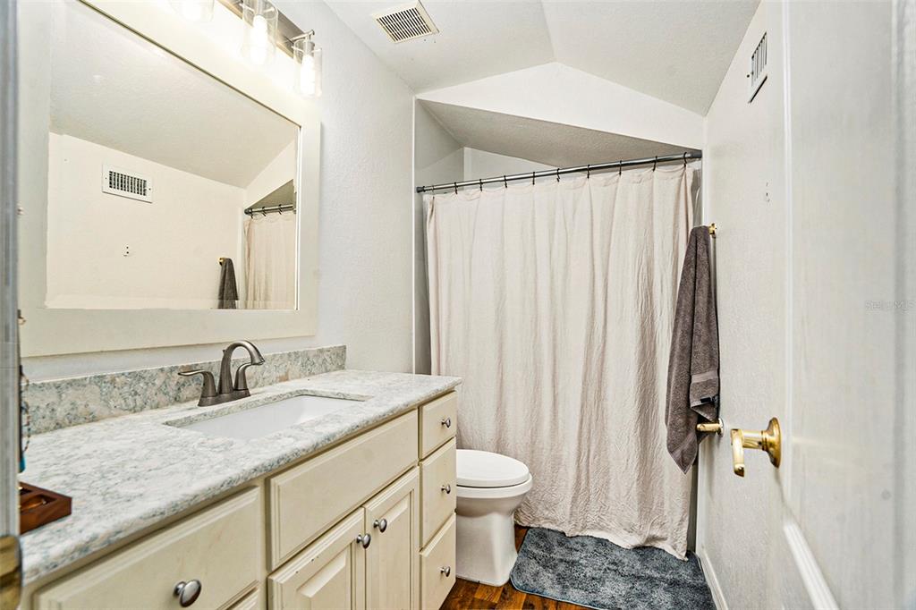 7309 Quail Meadow Road Plant City, FL 33565 - Photo 22 of 24 a bathroom with a granite countertop sink toilet and shower