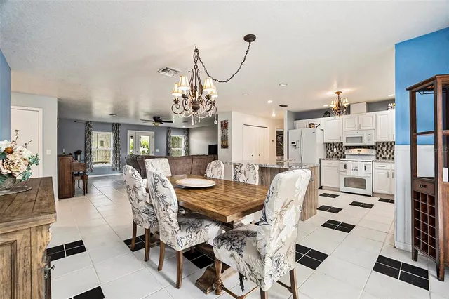 a living room with furniture kitchen view and a flat screen tv