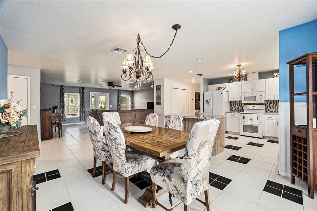 7309 Quail Meadow Road Plant City, FL 33565 - Photo 7 of 24 a view of a dining room with furniture and chandelier