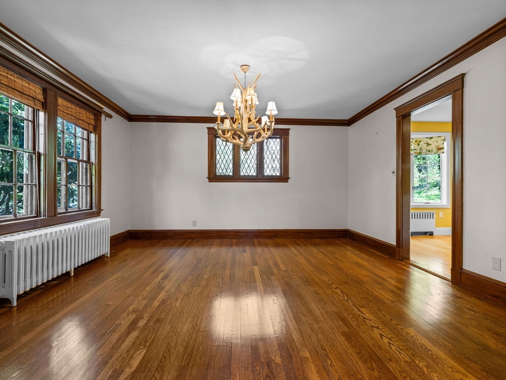 81 Garden Road Wellesley, MA 02481 - Photo 3 of 17 a view of an empty room with wooden floor and a window