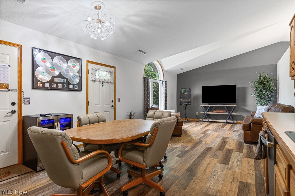 808 Ryan Road, Unit 14 Medina, OH 44256 - Photo 15 of 40 Open-concept living area featuring vaulted ceilings, wood-finish flooring, and a neutral color palette
