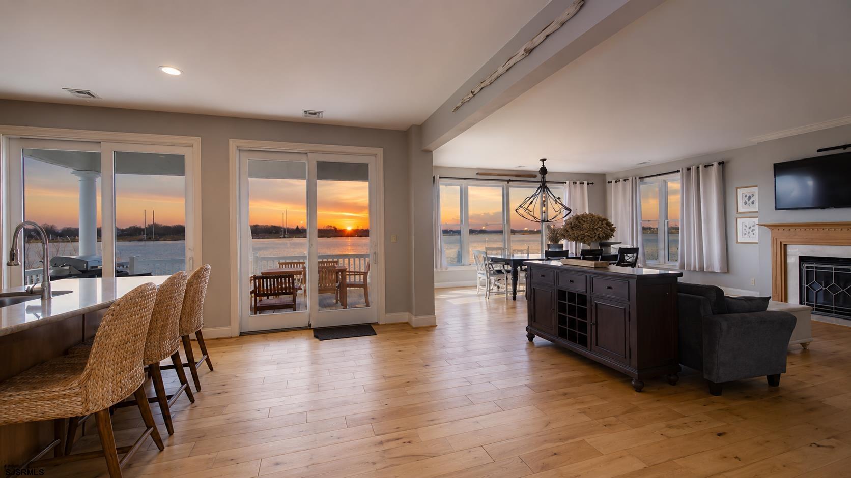 2070 West Riverside Drive Atlantic City, NJ 08401 - Photo 5 of 40 a living room with furniture a flat screen tv and floor to ceiling window