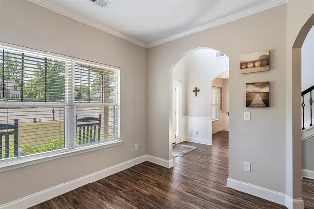 a spacious bedroom with a bed a couch and a window