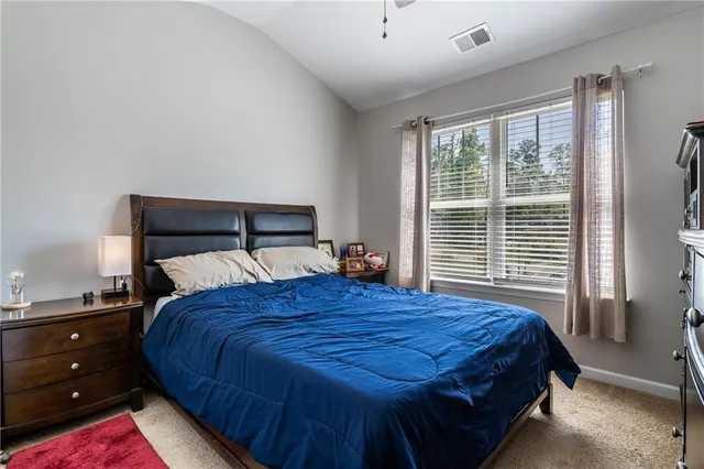 a view of a field with trees in the background