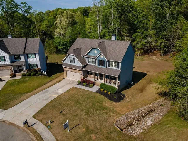 a kitchen with stainless steel appliances granite countertop a kitchen island hardwood floor and a sink