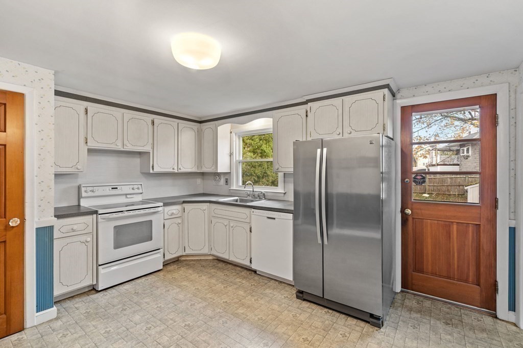 11 Christopher Drive Milton, MA 02186 - Photo 11 of 34 a kitchen with a refrigerator sink and cabinets